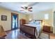 A sunny bedroom with hardwood floors, ceiling fan, and access to the outside at 6418 E Sunnyside Dr, Scottsdale, AZ 85254