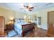 Cozy bedroom showcasing hardwood floors, ceiling fan, and a closet with mirrored doors at 6418 E Sunnyside Dr, Scottsdale, AZ 85254
