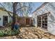 Private courtyard featuring brick pavers, a stone wall, and inviting foliage at 6418 E Sunnyside Dr, Scottsdale, AZ 85254