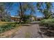 View of the home from the driveway, showing the garage and desert landscaping at 6418 E Sunnyside Dr, Scottsdale, AZ 85254