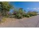 View of the home from the street, showing the driveway, desert landscaping, and house number at 6418 E Sunnyside Dr, Scottsdale, AZ 85254