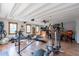 Spacious home gym with equipment, wood floors, and natural light from multiple windows at 6418 E Sunnyside Dr, Scottsdale, AZ 85254