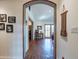 Elegant hallway featuring a decorative archway, wood floors, and stylish decor at 6418 E Sunnyside Dr, Scottsdale, AZ 85254