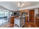 Modern kitchen with stainless appliances, tiled flooring, and a breakfast bar with stools at 6418 E Sunnyside Dr, Scottsdale, AZ 85254