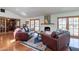 Warm and inviting living room featuring a fireplace, French doors, and comfortable leather seating at 6418 E Sunnyside Dr, Scottsdale, AZ 85254