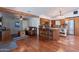 Open concept living and kitchen area boasting hardwood and terracotta flooring, beams and stainless appliances at 6418 E Sunnyside Dr, Scottsdale, AZ 85254