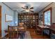Well-lit office features a built-in bookcase and dual desks, perfect for a home workspace at 6418 E Sunnyside Dr, Scottsdale, AZ 85254