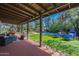 Comfortable covered patio with lounge chairs overlooks the backyard and pool, perfect for outdoor relaxation at 6418 E Sunnyside Dr, Scottsdale, AZ 85254