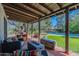 Covered patio with comfortable seating, fire pit, and a view of the inviting pool and garden at 6418 E Sunnyside Dr, Scottsdale, AZ 85254