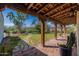 Picturesque porch with brick flooring, wooden support beams and a view of the expansive yard at 6418 E Sunnyside Dr, Scottsdale, AZ 85254
