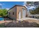 Exterior shot of a detached garage with a roll-up door and adjacent RV parking on a concrete pad at 6418 E Sunnyside Dr, Scottsdale, AZ 85254