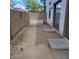 Small backyard with privacy wall, patio and sliding door at 6908 S 8Th Dr, Phoenix, AZ 85041