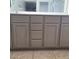 Bathroom vanity featuring gray cabinets, modern hardware and a white countertop at 6908 S 8Th Dr, Phoenix, AZ 85041
