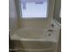 Bright bathroom featuring a built-in bathtub with chrome fixtures at 6908 S 8Th Dr, Phoenix, AZ 85041