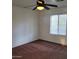 Cozy bedroom with carpet, a ceiling fan, and a bright window at 6908 S 8Th Dr, Phoenix, AZ 85041