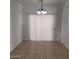 Bright dining area with tile floors, modern lighting, and sliding door access at 6908 S 8Th Dr, Phoenix, AZ 85041