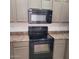 Efficient kitchen featuring a black oven and microwave paired with tan counters at 6908 S 8Th Dr, Phoenix, AZ 85041