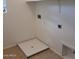 Empty laundry room featuring utility sink and overhead shelving at 6908 S 8Th Dr, Phoenix, AZ 85041