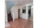 Inviting living room featuring a staircase, wood-look floors, and an open layout to the kitchen at 6908 S 8Th Dr, Phoenix, AZ 85041