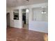 Open-concept living area showcasing wood floors and views of the adjacent kitchen and dining spaces at 6908 S 8Th Dr, Phoenix, AZ 85041