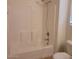 White tiled shower and tub combination with chrome fixtures at 6908 S 8Th Dr, Phoenix, AZ 85041