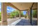 A covered patio overlooks a serene backyard with desert landscaping, showcasing outdoor living and privacy at 6941 E Snowdon St, Mesa, AZ 85207