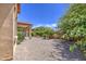 A view of the home's backyard featuring gravel ground cover and desert-friendly landscaping at 6941 E Snowdon St, Mesa, AZ 85207