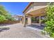 A view of the home's backyard, featuring a gravel ground cover and covered patio with view of the neighbor at 6941 E Snowdon St, Mesa, AZ 85207