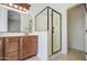 Bathroom showing the glass shower and wood cabinet under mirror at 6941 E Snowdon St, Mesa, AZ 85207