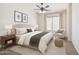 Bright bedroom featuring a ceiling fan, area rug, side table, chair, and large window for natural light at 6941 E Snowdon St, Mesa, AZ 85207
