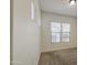 Bedroom with neutral carpet, white walls, and two windows with blinds, creating a bright and airy space at 6941 E Snowdon St, Mesa, AZ 85207