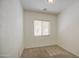 A simple bedroom with neutral carpet, white walls, and a window with blinds, creating a calm and inviting space at 6941 E Snowdon St, Mesa, AZ 85207