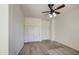 Bright bedroom with ceiling fan, double closets, and neutral carpet at 6941 E Snowdon St, Mesa, AZ 85207