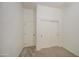 Bedroom featuring neutral carpet, white walls, a standard door and closet with sliding doors, great for storage options at 6941 E Snowdon St, Mesa, AZ 85207