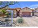 Inviting home featuring mature landscaping, a tile roof, and a large driveway at 6941 E Snowdon St, Mesa, AZ 85207