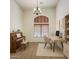 Versatile room featuring a piano, built-in shelving, arched window, and desk perfect for a home office at 6941 E Snowdon St, Mesa, AZ 85207