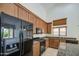 Well lit kitchen with stainless steel appliances, granite countertops, and ample cabinet space at 6941 E Snowdon St, Mesa, AZ 85207