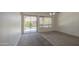 Bright living room with sliding glass door and neutral carpet at 6941 E Snowdon St, Mesa, AZ 85207