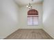 Spacious living room with large window, neutral carpet, and chandelier at 6941 E Snowdon St, Mesa, AZ 85207