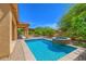 Sparkling pool and spa surrounded by lush landscaping and a covered patio, perfect for outdoor enjoyment at 6941 E Snowdon St, Mesa, AZ 85207