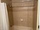 Tiled bathtub with shower curtain featuring neutral-colored tiles and a sleek showerhead at 7157 E Rancho Vista Dr # 1004, Scottsdale, AZ 85251