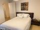 Bedroom with a king size bed, nightstand, and a decorative piece of art hanging above the bed at 7157 E Rancho Vista Dr # 1004, Scottsdale, AZ 85251