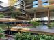 A multi-story building boasts outdoor dining, greenery-filled balconies, and stylish architectural details at 7157 E Rancho Vista Dr # 1004, Scottsdale, AZ 85251
