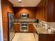 Modern kitchen boasts stainless steel appliances, granite countertops, and ample cherry wood cabinetry at 7157 E Rancho Vista Dr # 1004, Scottsdale, AZ 85251