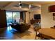 Comfortable living room has modern furniture, an entertainment center, and sliding glass door to patio at 7157 E Rancho Vista Dr # 1004, Scottsdale, AZ 85251