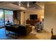 Comfortable living room has modern furniture, an entertainment center, and sliding glass door to patio at 7157 E Rancho Vista Dr # 1004, Scottsdale, AZ 85251
