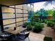Cozy outdoor patio with a dining set surrounded by lush landscaping and privacy features, creating a serene retreat at 7157 E Rancho Vista Dr # 1004, Scottsdale, AZ 85251