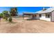 View of the backyard featuring an in-ground pool, mature trees, and a covered patio, creating an inviting outdoor space at 7231 W Sierra Vista Dr, Glendale, AZ 85303