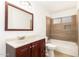 This bathroom features a shower-tub combination and wood-stained vanity at 7231 W Sierra Vista Dr, Glendale, AZ 85303