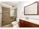 This bathroom features a glass shower and wood-stained vanity at 7231 W Sierra Vista Dr, Glendale, AZ 85303